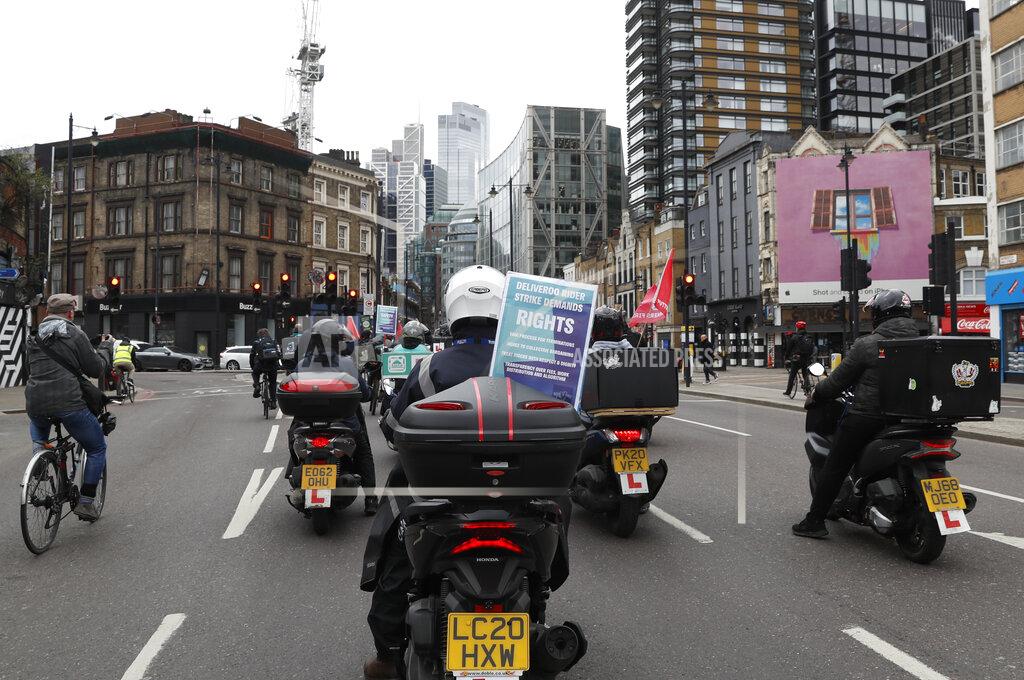 Alastair Grant Gig economy riders for app-based meal delivery platform Deliveroo demonstrate near the company headquarters in London, Wednesday, April 7, 2021. The strike coincides with the first day of unconditional trading for Deliveroo shares, which went public last week in a stock market offering.(AP Photo/Alastair Grant)