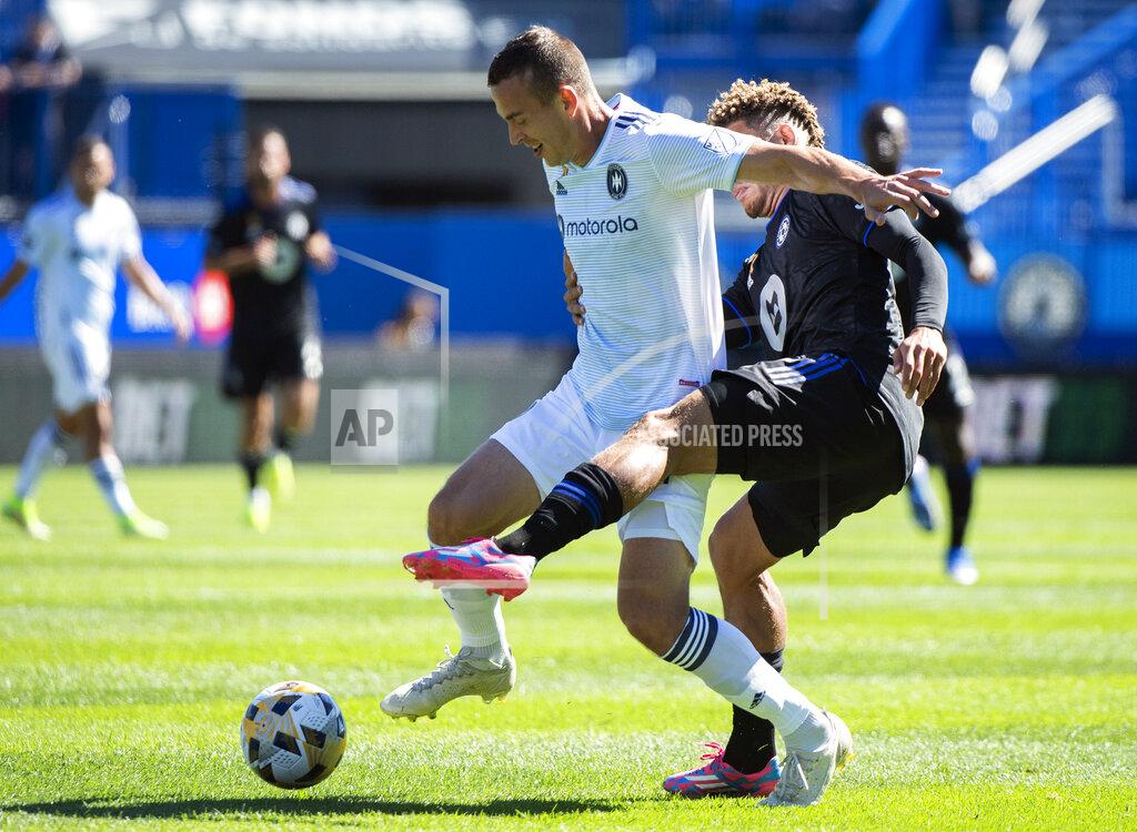Graham Hughes CF Montreal's Zorhan Bassong, right, challenges Chicago Fire FC's Boris Sekulic during first half MLS soccer action in Montreal, Sunday, Sept. 19, 2021. (Graham Hughes/The Canadian Press via AP)