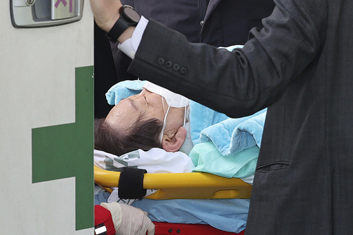 FILE - South Korean opposition leader Lee Jae-myung on a stretcher arrives at a heliport in Seoul, South Korea, Tuesday, Jan. 2, 2024. South Korea police on Wednesday, Jan. 3, raided the residence and office of a man who stabbed the country&rsquo;s opposition leader, Lee Jae-myung, in the neck earlier this week in an attack that left him hospitalized in an intensive care unit, officials said. (Im Hwa-young/Yonhap via AP, File)