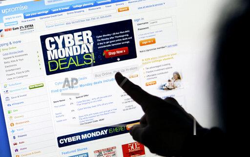FILE - In this Nov. 29, 2010 file photo, a consumer looks at Cyber Monday sales on her computer at her home in Palo Alto, Calif. Consumers are expected to spend between $10.2 billion and $11.3 billion on Monday, Nov. 29, 2021 making it once again the biggest online shopping day of the year, according to Adobe Digital Economy Index. (AP Photo/Paul Sakuma, File)