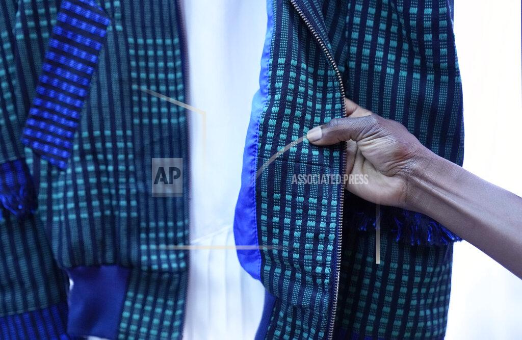 Antonio Calanni Fashion designer Nyny touches her creation, part of the Black Lives Matter Spring Summer 2022 collective fashion event, unveiled during the Milan Fashion Week in Milan, Italy, Tuesday, Sept. 21, 2021. (AP Photo/Antonio Calanni)
