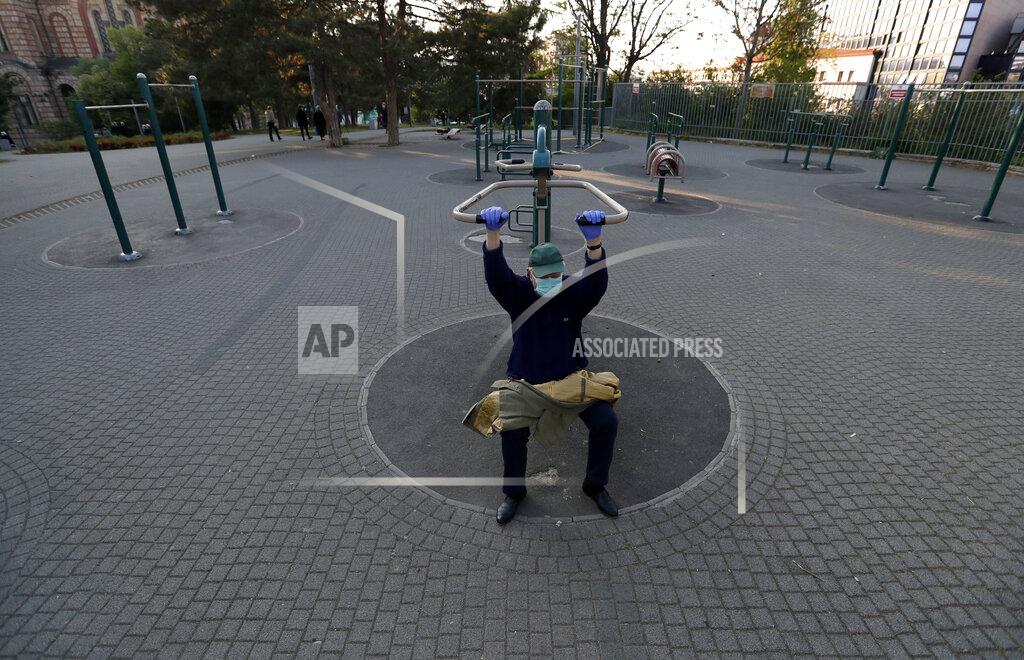 Darko Vojinovic FILE - In this Friday, April 24, 2020 file photo, a man wearing a mask against the spread of the new coronavirus exercises in a park during a curfew in Belgrade, Serbia. Serbia's president Aleksandar Vucic has cancelled his party's pre-election rallies and officials in Bosnia, Macedonia and Albania are appealing on citizens to respect protection measures after relaxation of rules against the new coronavirus led to a recent spike in cases in the Balkan countries. (AP Photo/Darko Vojinovic, File)