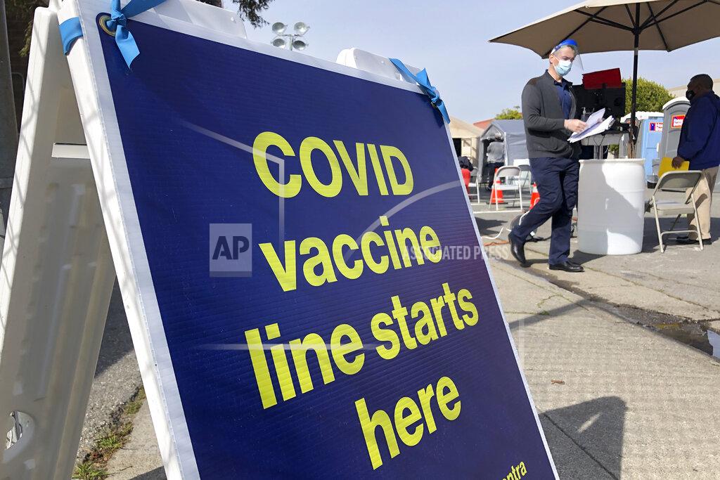 Haven Daley FILE - In this Feb. 8, 2021 file photo a sign is displayed at a COVID-19 vaccine site in the Bayview neighborhood of San Francisco. San Francisco city workers will be required to be vaccinated against the coronavirus when a vaccine receives full federal approval. The policy covering 35,000 municipal workers may be the first by any city or county in the U.S., the San Francisco Chronicle reported Wednesday, June 23. (AP Photo/Haven Daley,File)