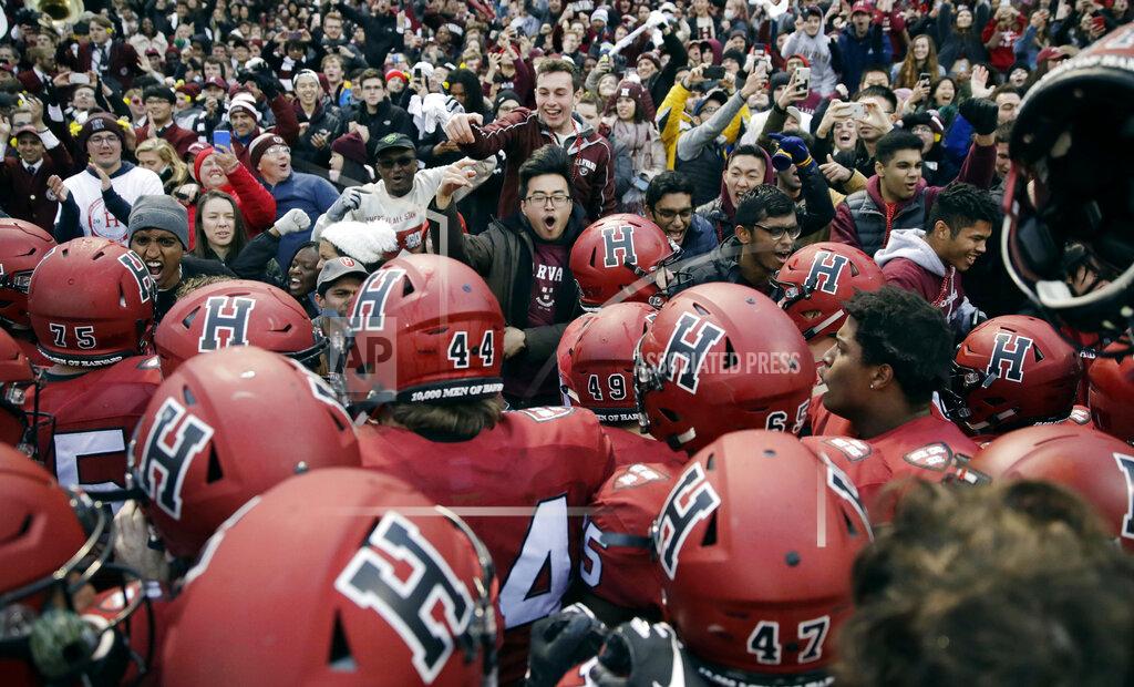 FILE - In this Nov. 17, 2018, file photo, Harvard players, students and fans celebrate their 45-27 win over Yale after an NCAA college football game at Fenway Park in Boston. Harvard defeated Yale. The Ivy League has canceled all fall sports because of the coronavirus pandemic. (AP Photo/Charles Krupa, File)