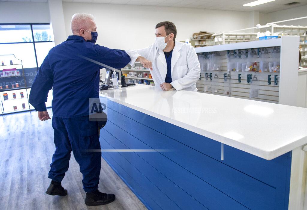 Chris Granger Admiral Brett Giroir, the Assistant Secretary for Health at the U.S. Department of Health and Human Services, elbow bumps Pharmacist Stacey LaBorde as the two meet at LaPharmacy in Elmwood, La., to discuss the coronavirus vaccine distribution on Wednesday, Dec. 2, 2020. (Chris Granger/The Advocate via AP)
