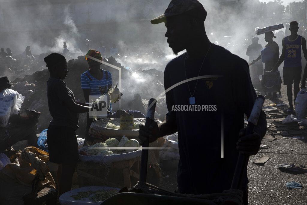 Rodrigo Abd Vendors shred cabbage in the Croix des Bosalles market, in Port-au-Prince, Haiti, Monday, Sept. 13, 2021. The city's main food market extends from the southern entrance of the port to the parliament, on ground where enslaved people were sold before independence. To enter the market today, one must walk through a gang gauntlet. (AP Photo/Rodrigo Abd)