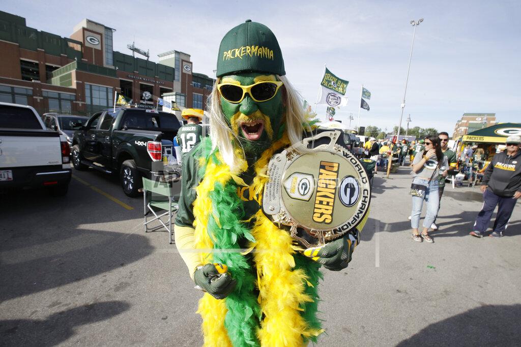 Mike Roemer Green Bay Packers fan Brad Borcharet walks through the parking lot outside Lambeau Field before the start of an NFL football game between th Packers and the Philadelphia Eagles, Thursday, Sept. 26, 2019, in Green Bay, Wis. (AP Photo/Mike Roemer)
