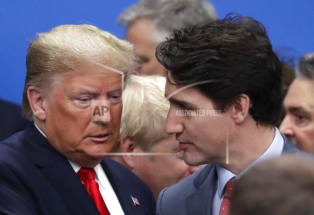 FILE - In this Wednesday, Dec. 4, 2019, file photo, U.S. President Donald Trump, left, and Canadian Prime Minister Justin Trudeau arrive for a round table meeting during a NATO leaders meeting at The Grove hotel and resort in Watford, Hertfordshire, England. Trump spent four years upending seven decades of American trade policy. He started a trade war with China, slammed America’s closest allies by taxing their steel and aluminum and terrified Big Business by threatening to take a wrecking ball to $1.4 trillion in annual trade with Mexico and Canada. (AP Photo/Evan Vucci, File)