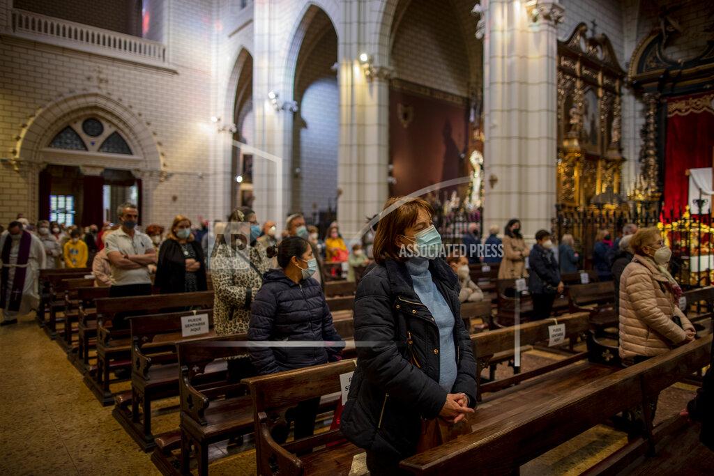 Manu Fernandez People wearing face masks to protect against the spread of coronavirus attend a mass at Santa Cruz church in downtown Madrid, Spain, Wednesday, March 31, 2021. Spain is bracing for another potential sharp increase in coronavirus cases. And with the vaccine rollout being outpaced by the new more contagious variant of the virus, authorities are asking for citizens to intensify their precautions to "buy time" for the shots to arrive. (AP Photo/Manu Fernandez)