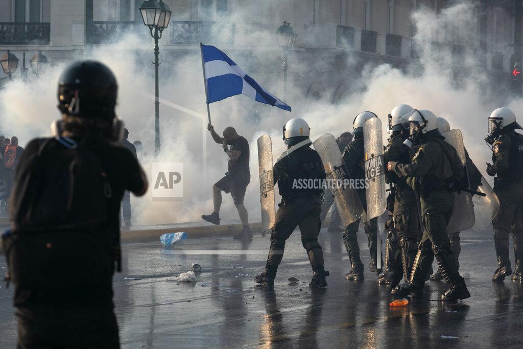 Yorgos Karahalis Greek police use tear gas to disperse anti-vaccine protesters during a rally at Syntagma square, central Athens, on Wednesday, July 21, 2021. Thousands of people protested against Greek government's measures to curb rising COVID-19 infections and drive up vaccinations in the country where almost 50% of Greeks and country residents have received at least one dose of the vaccine. (AP Photo/Yorgos Karahalis)