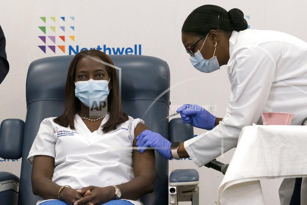 Mark Lennihan FILE - In this Monday, Dec. 14, 2020 file photo, Sandra Lindsay, left, a nurse at Long Island Jewish Medical Center, is inoculated with the Pfizer-BioNTech COVID-19 vaccine by Dr. Michelle Chester, Monday, Dec. 14, 2020, in the Queens borough of New York. (AP Photo/Mark Lennihan, Pool. File)
