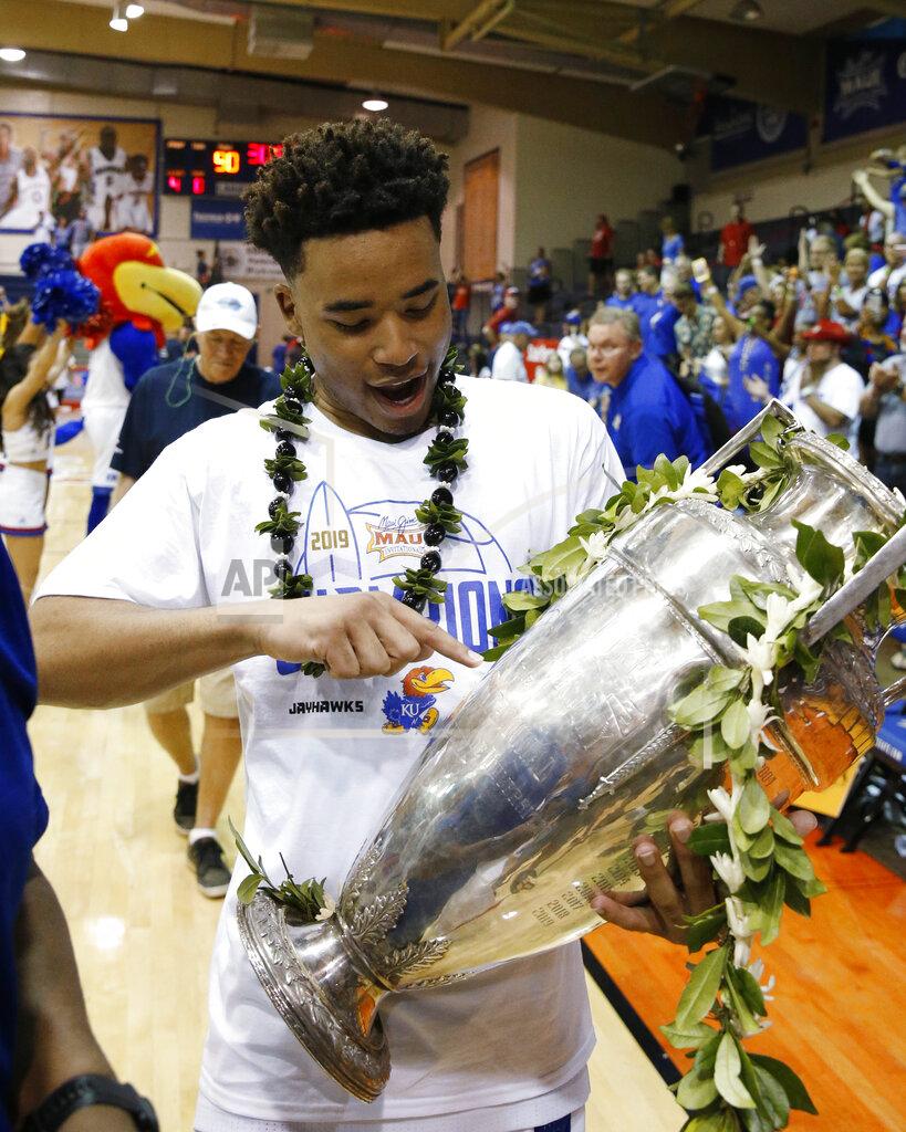 Marco Garcia Kansas guard Devon Dotson holds the Maui Invitational trophy Wednesday, Nov. 27, 2019, in Lahaina, Hawaii. Kansas defeated Dayton in 90-84 in overtime in an NCAA college basketball game for the title. (AP Photo/Marco Garcia)
