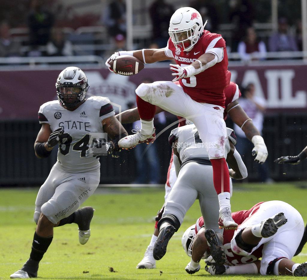 Jim Lytle Arkansas running back Rakeem Boyd (5) hurdles a Mississippi State player on his way to a first down during the first half of an NCAA college football game in Starkville, Miss., Saturday, Nov. 17, 2018. Mississippi State won 52-6. (AP Photo/Jim Lyle)