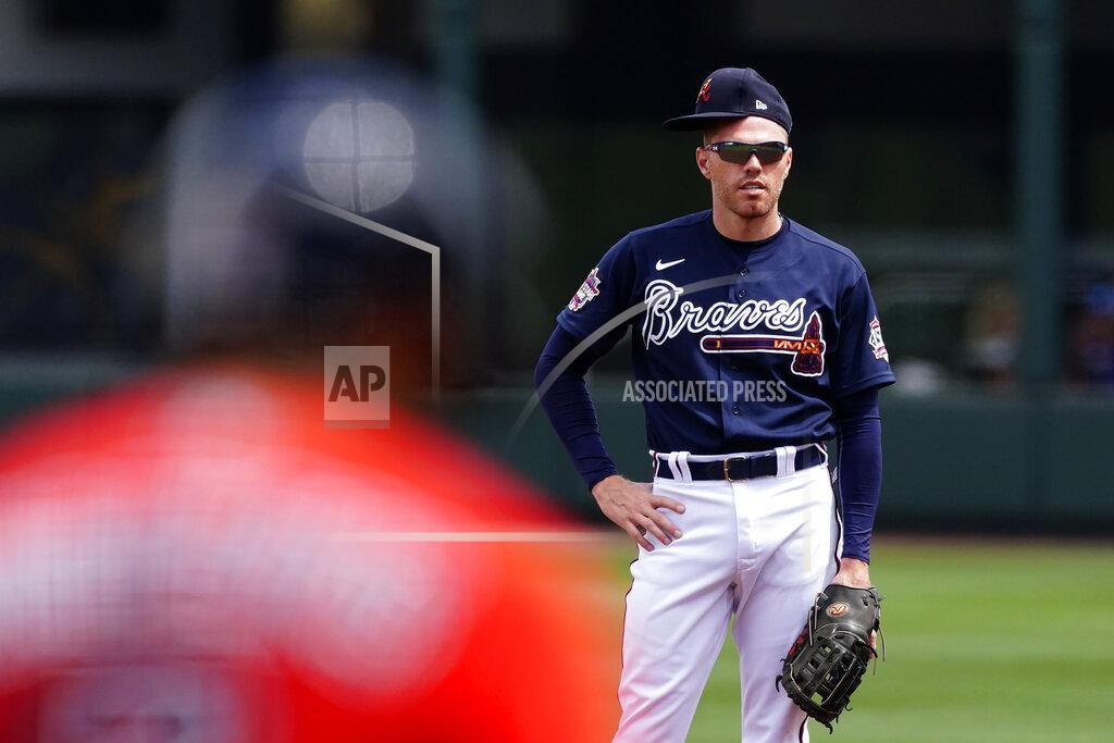 John Bazemore Atlanta Braves first baseman Freddie Freeman wears his hat sideways as he waits for Boston Red Sox' Xander Bogaerts (2) to bat during the first inning of a spring training baseball game on Tuesday, March 23, 2021, in North Port, Fla. (AP Photo/John Bazemore)