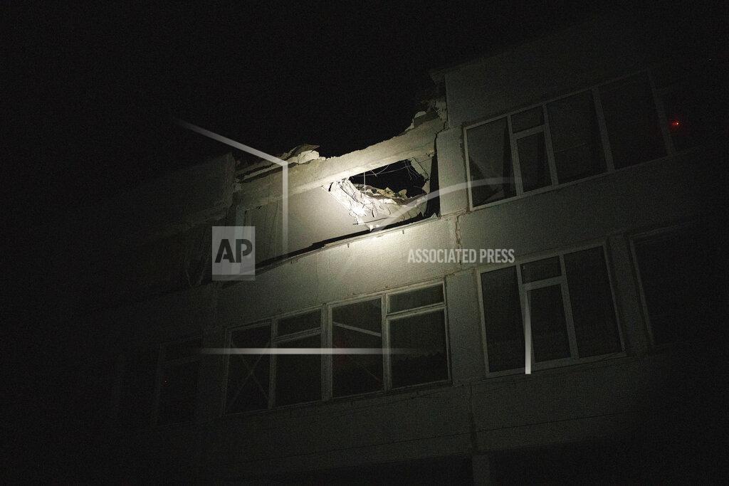 Felipe Dana FILE - A Ukrainian police officer uses a flashlight to illuminate a school that was hit by a Russian attack, as he patrols during a night curfew in Kharkiv, Ukraine, Sunday, March 27, 2022. Targeting schools and other civilian infrastructure is a war crime. Experts say wide-scale wreckage can be used as evidence of Russian intent, and to refute claims that schools were simply collateral damage. (AP Photo/Felipe Dana, File)