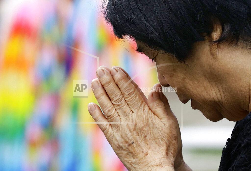 085123+0900 A bereaved family member prays for the victims of U.S. atomic bombing at the Atomic Bomb Hypocenter Park in Nagasaki, southern Japan, Sunday, Aug. 9, 2020. Nagasaki marked the 75th anniversary of the atomic bombing on Sunday. (Kyodo News via AP)