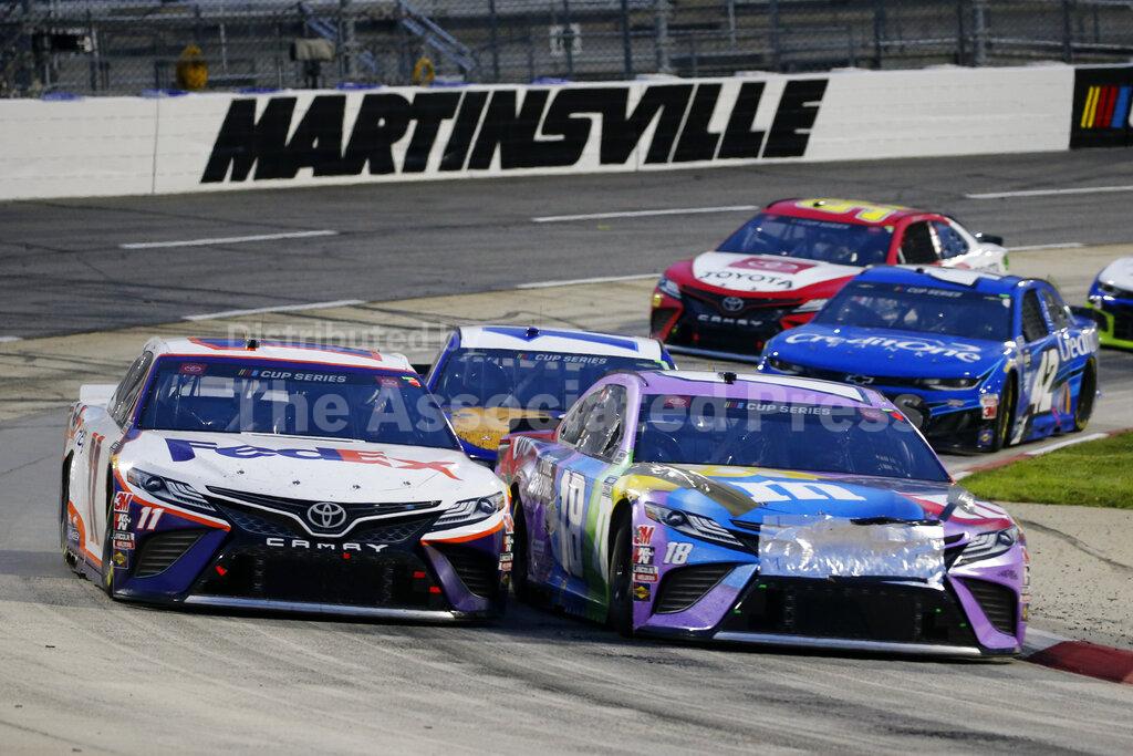 FILE - In this June 10, 2020, file photo, Denny Hamlin (11) and Kyle Busch (18) come through a turn during a NASCAR Cup Series auto race at in Martinsville, Va. Hamlin's dazzling season could potentially collapse if things go sideways Sunday, Oct. 31, 2020, at Martinsville Speedway, NASCAR's oldest and shortest track that has been slotted as the final playoff elimination race. (AP Photo/Steve Helber, File)