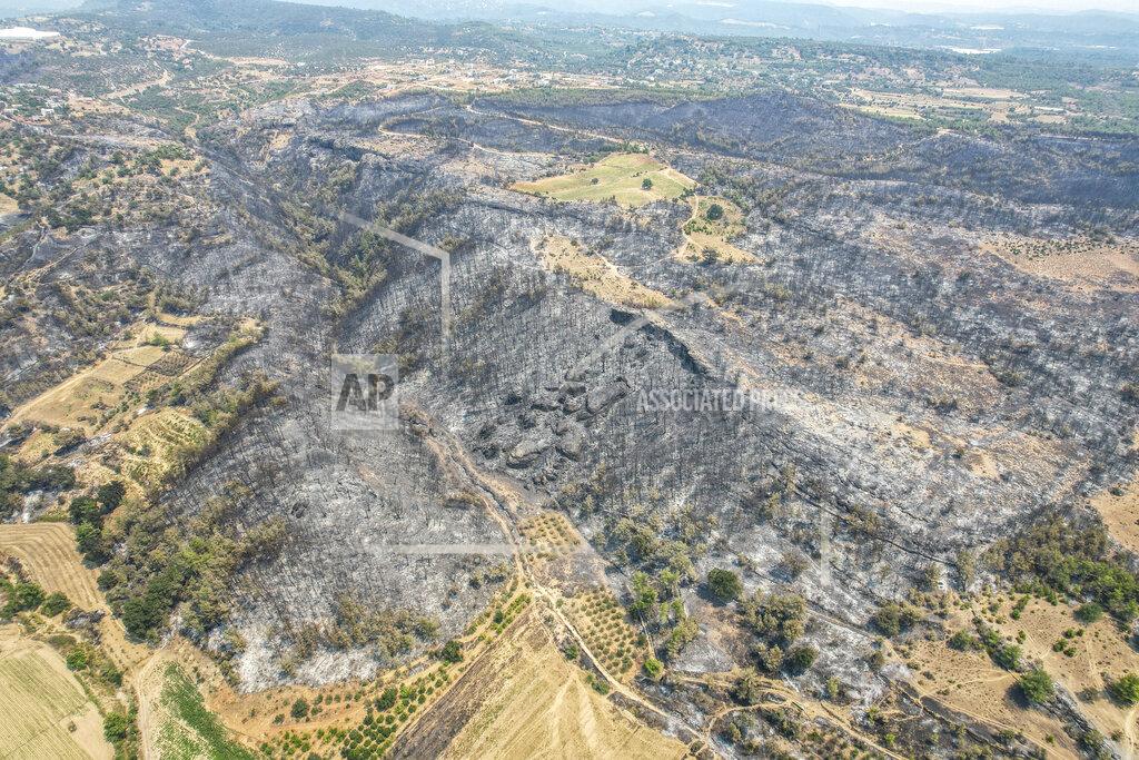 Uncredited An aerial photo shows the destruction caused by wildfires near the Mediterranean coastal town of Manavgat, Antalya, Turkey, Friday, July 30, 2021. The death toll in a string of wildfires raging in southern Turkey rose to four, officials said Friday, as fire crews continued to battle blazes that burned down homes and forced people to evacuate settlements and beach resorts. Firefighters were still tackling wildfires in 14 locations in six provinces in Turkey's Mediterranean and southern Aegean region, President Recep Tayyip Erdogan told reporters. (AP Photo)