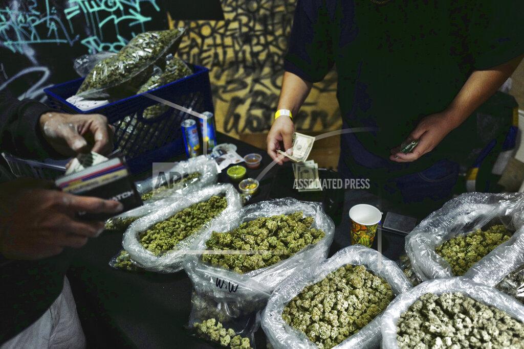 Richard Vogel FILE - In this April 15, 2019, file photo, a vendor makes change for a marijuana customer at a cannabis marketplace in Los Angeles. Voters in four states could embrace broad legal marijuana sales on Election Day, setting the stage for a watershed year for the industry that could snowball into neighboring states as well as reshape policy on Capitol Hill. The Nov. 3, 2020, contests will take place in markedly different regions of the country, New Jersey, Arizona, South Dakota and Montana and approval of the proposals would highlight how public acceptance of cannabis is cutting across geography, demographics and the nation's deep political divide. (AP Photo/Richard Vogel, File)