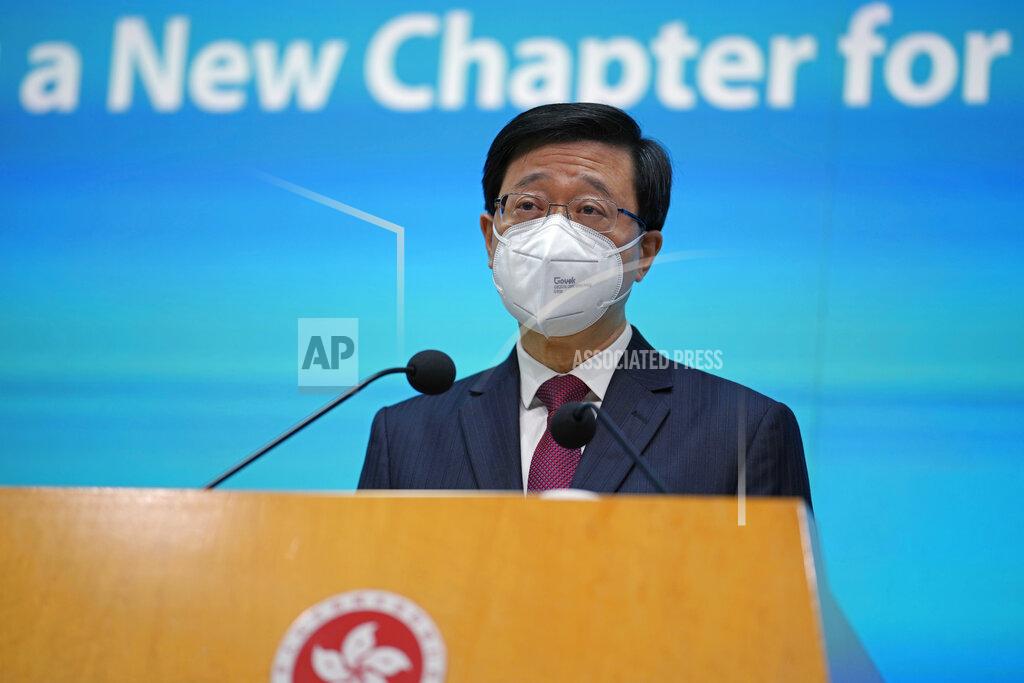 Kin Cheung Hong Kong Chief Executive John Lee speaks during a news conference in Hong Kong, Tuesday, July 5, 2022. Lee said Tuesday in his first news conference since taking the reins that he will work towards legislating easing restrictions for travelers, but that it must be balanced with limiting the spread of the coronavirus so as not to overwhelm the healthcare system. (AP Photo/Kin Cheung)