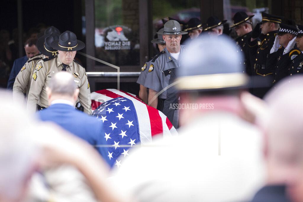 Silas Walker Law enforcement officers carry the casket of Floyd County Deputy William Petry to the hearse after the funeral service at the Mountain Arts Center in Prestonsburg, Ky., Tuesday, July 5, 2022. Petry and two Prestonsburg city police officers were killed while serving a warrant at a home in the county. (Silas Walker/Lexington Herald-Leader via AP)