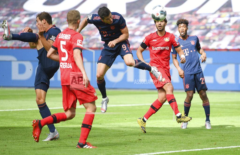 Matthias Hangst Robert Lewandowski, center, of Municg scores his team's fourth during the German Bundesliga soccer match between Bayer Leverkusen and Bayern Munich in Leverkusen, Germany, Saturday, June 6, 2020. (Matthias Hangst, Pool via AP)