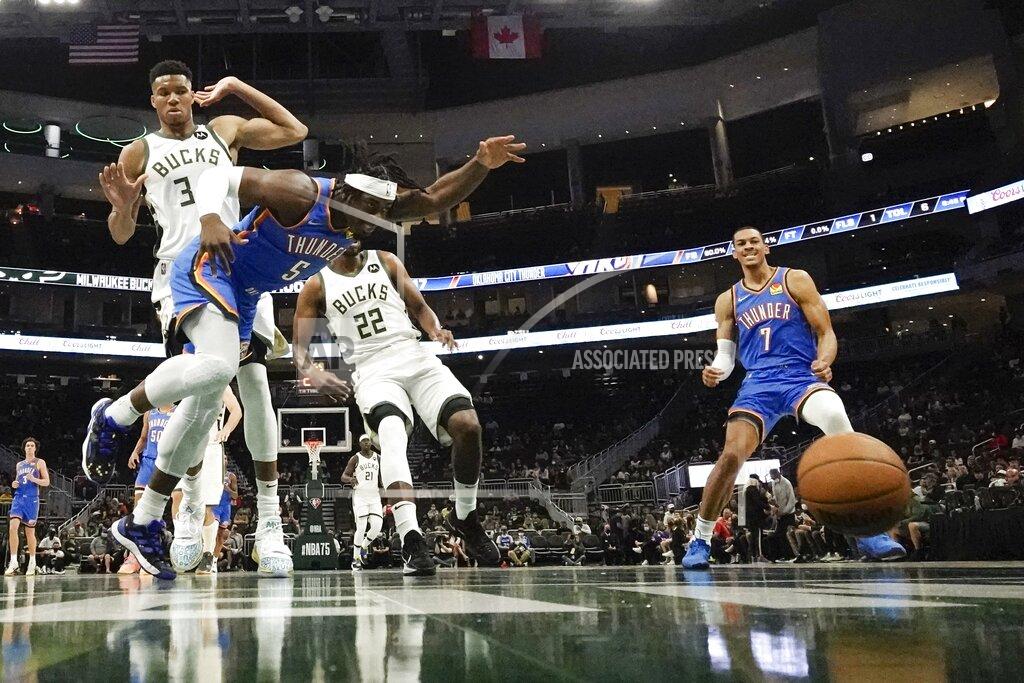 Morry Gash Oklahoma City Thunder's Luguentz Dort and Milwaukee Bucks' Giannis Antetokounmpo go after a loose ball during the first half of an NBA preseason basketball game Sunday, Oct. 10, 2021, in Milwaukee. (AP Photo/Morry Gash)