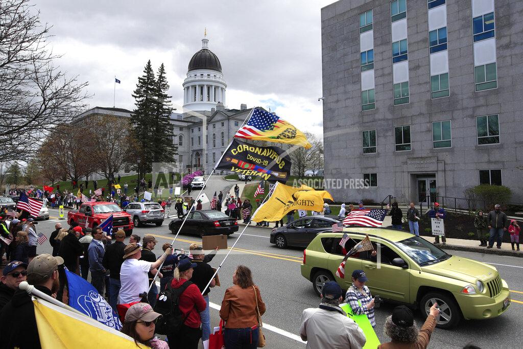 Robert F. Bukaty Protesters rally against the executive orders by Maine Gov. Janet Mills keep some of Maine businesses closed to help prevent the spread of coronavirus, Saturday, May 16, 2020, in Augusta, Maine. (AP Photo/Robert F. Bukaty)