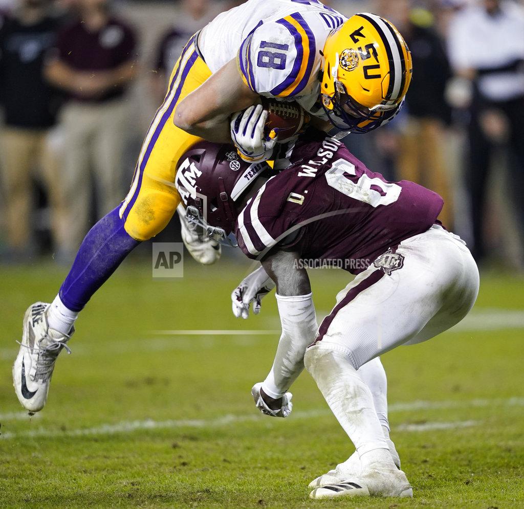 David J. Phillip LSU tight end Foster Moreau (18) goes over Texas A&M defensive back Donovan Wilson (6) to score a touchdown during the second half of an NCAA college football game Saturday, Nov. 24, 2018, in College Station, Texas. Texas A&M won 74-72 in seven overtimes.(AP Photo/David J. Phillip)