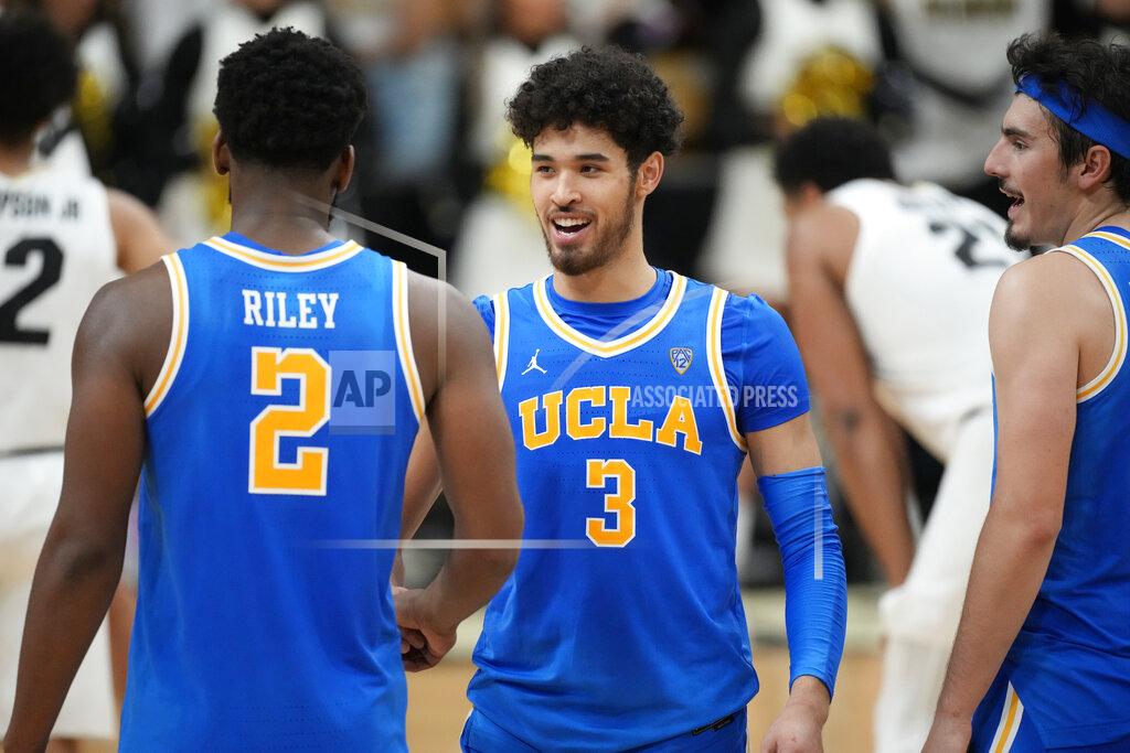 David Zalubowski UCLA guard Johnny Juzang (3 celebrates with forward Cody Riley, left, and guard Jaime Jaquez Jr. near the end of the team's NCAA college basketball game against Colorado on Saturday, Jan. 22, 2022, in Boulder, Colo. UCLA won 71-65. (AP Photo/David Zalubowski)