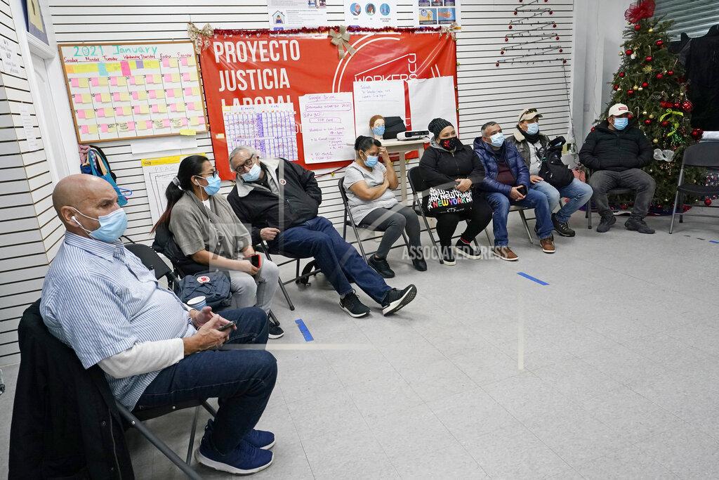 Kathy Willens A group of immigrants gather at the Workers Justice Center as they watch Joe Biden's presidential inauguration, Wednesday, Jan. 20, 2021, in the Sunset Park neighborhood of Brooklyn in New York. Most were disappointed Biden didn't mention immigration reform in his inaugural speech. (AP Photo/Kathy Willens)