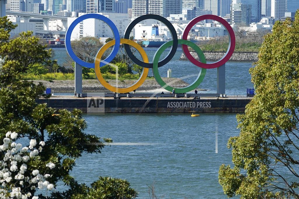 FILE - In this March 24, 2020, file photo, the Olympic rings is seen at Tokyo's Odaiba district. The postponed Tokyo Olympics are to open in just under nine months, and there are still far more questions than answers. Organizers and the International Olympic Committee say they are working on a vast number of contingency plans to hold the Games in the midst of a pandemic. (AP Photo/Eugene Hoshiko, File)