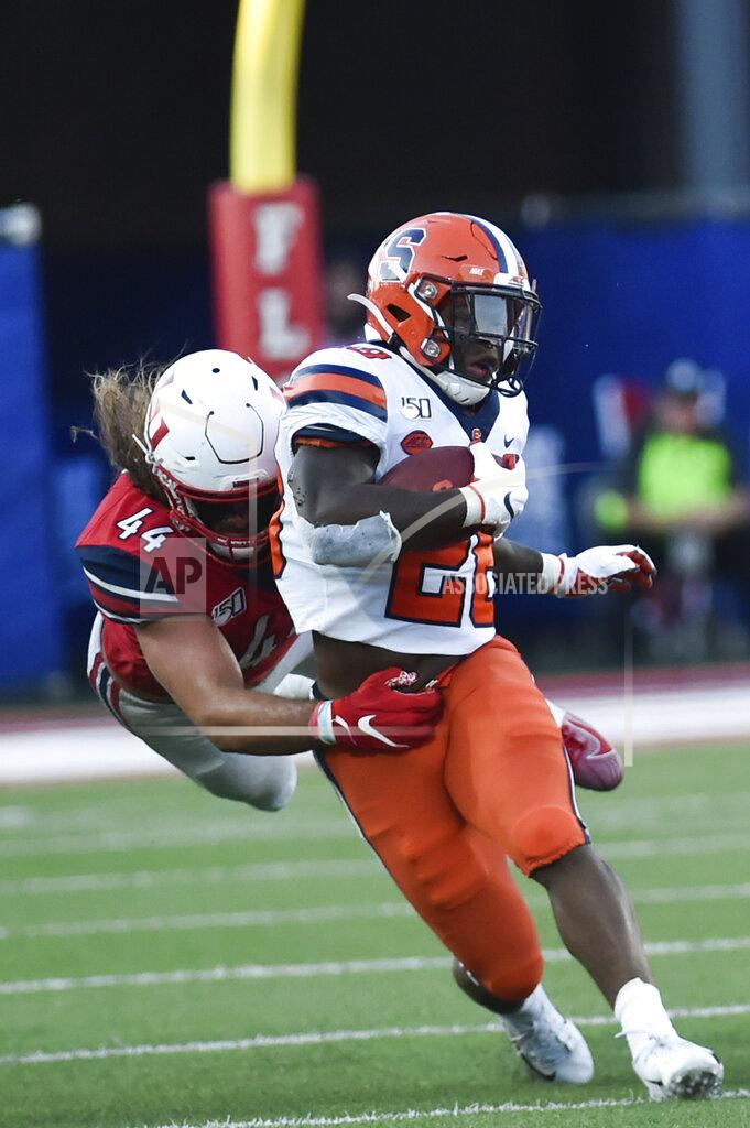 Emily Elconin Liberty defensive lineman Austin Lewis tackles Syracuse running back Jarveon Howard during the first game of the season against on Saturday, August 31, 2019 at Williams Stadium.(Emily Elconin/The News & Advance via AP)