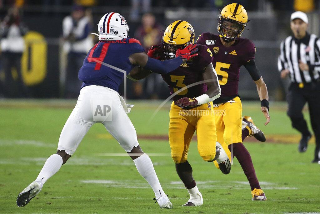 Darryl Webb Arizona State quarterback Jayden Daniels (5) gets a block from his running back Eno Benjamin (3) against Arizona's Christian Roland-Wallace during the first half of an NCAA college football game, Saturday, Nov. 30, 2019, in Tempe, Ariz. (AP Photo/Darryl Webb)