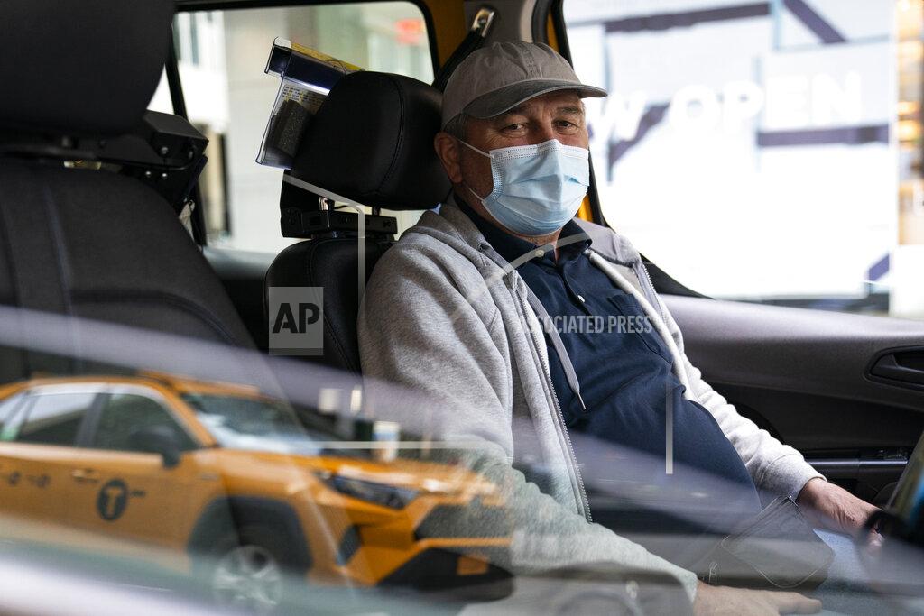 John Minchillo Nicolae Hent sits for a portrait in his taxi outside a midtown Manhattan hotel, in New York on March 19, 2021. “Not an easy year to go through in 2020," Hent said. "Hopefully, this one will be better, but God knows.” (AP Photo/John Minchillo)