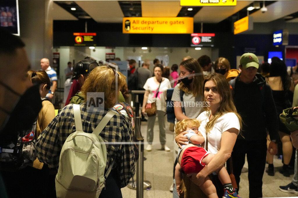 Frank Augstein FILE - Travellers queue at security at Heathrow Airport in London, Wednesday, June 22, 2022. After two years of pandemic restrictions, travel demand is back with a vengeance but airlines and airports that slashed jobs during the depths of the COVID-19 crisis are struggling to keep up. With the busy summer tourism season underway in Europe, passengers are encountering chaotic scenes at airports, including lengthy delays, canceled flights and headaches over lost luggage. (AP Photo/Frank Augstein, File)