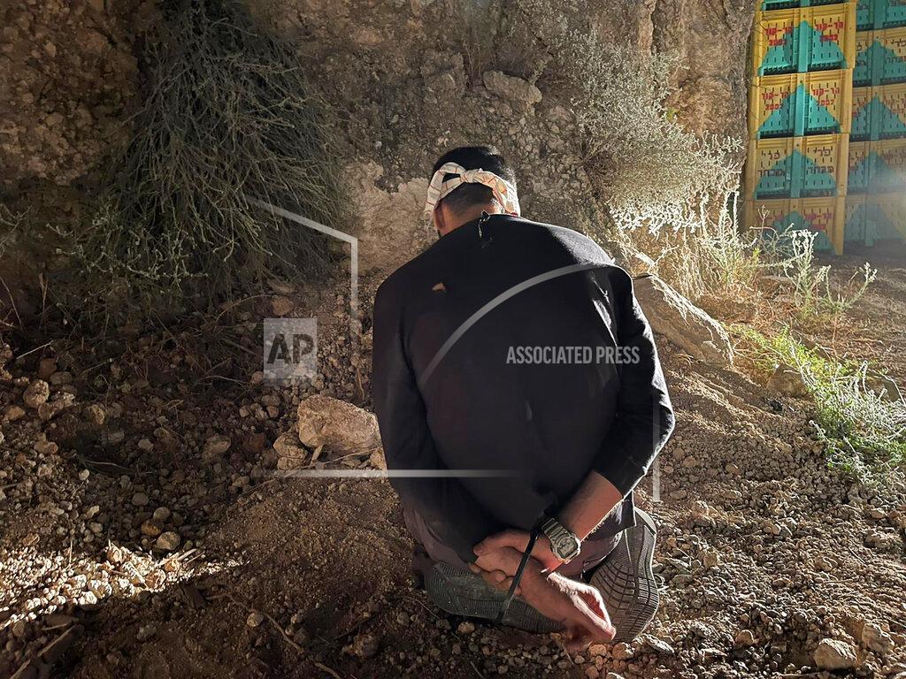 Uncredited In this photo provided by Israel Police, Mohammed Aradeh, one of the six Palestinian fugitives, is blindfolded and handcuffed after being recaptured in the Arab town of Umm al-Ghanam, northern Israel, Saturday, Sept. 11, 2021. Israeli police on Saturday said they have arrested four of the six Palestinians who broke out of a maximum-security prison this week including Zakaria Zubeidi, a famed militant leader whose exploits over the years have made him a well-known figure in Israel. (Israeli Police via AP)
