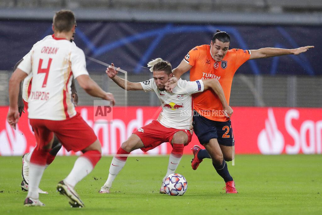 Markus Schreiber Leipzig's Kevin Kampl, centre, and Basaksehir's Enzo Crivelli challenge for the ball during a Group H Champions League soccer match between RB Leipzig and Istanbul Basaksehir at the RB Arena in Leipzig, Germany, Tuesday Oct. 20, 2020. (AP Photo/Markus Schreiber)