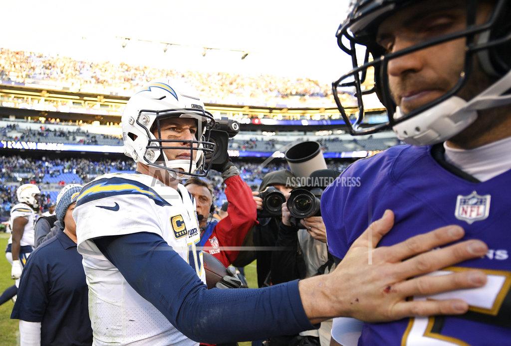 Nick Wass Los Angeles Chargers quarterback Philip Rivers, left, speaks with Baltimore Ravens quarterback Joe Flacco after an NFL wild card playoff football game, Sunday, Jan. 6, 2019, in Baltimore. Los Angeles won 23-17. (AP Photo/Nick Wass)