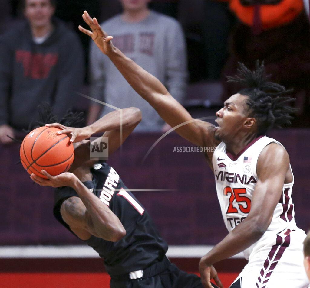 Matt Gentry North Carolina State's Dereon Seabron (1) attempts to shoot while defended by Virginia Tech's Justyn Mutts (25) during the second half of an NCAA college basketball game Tuesday, Jan. 4, 2022, in Blacksburg, Va. (Matt Gentry/The Roanoke Times via AP)
