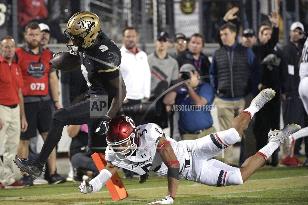 Phelan M. Ebenhack Central Florida running back Adrian Killins Jr. (9) scores a 42-yard touchdown in front of Cincinnati safety Darrick Forrest (5) after catching a pass during the second half of an NCAA college football game Saturday, Nov. 17, 2018, in Orlando, Fla. (AP Photo/Phelan M. Ebenhack)