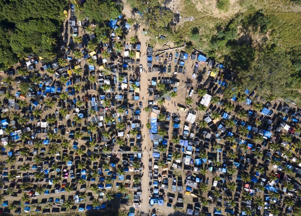 Mario Lobao FILE - In this May 26, 2021 file photo, tents and shacks cover land designated for a Petrobras refinery, called the "First of May Refugee Camp," which refers to the date the squatters camp sprung up amid the new coronavirus pandemic, in Itaguai, Rio de Janeiro state, Brazil. As Brazil hurtles toward an official COVID-19 death toll of 500,000, President Jair Bolsonaro has waged a campaign to downplay the virus’s seriousness and keep the economy humming. (AP Photo/Mario Lobao, File)