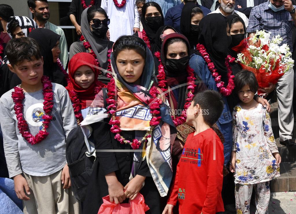 Waleed Ahmed Members of Afghanistan's women soccer team and their families pose for a photograph after they were greeted by officials of the Pakistan Football Federation, in Lahore, Pakistan, Wednesday, Sept. 15, 2021. Officials and local media said Wednesday that an unspecified number of Afghan women players and their family members were allowed to enter in Pakistan after apparently fleeing their country for security reasons. (AP Photo/Waleed Ahmed)