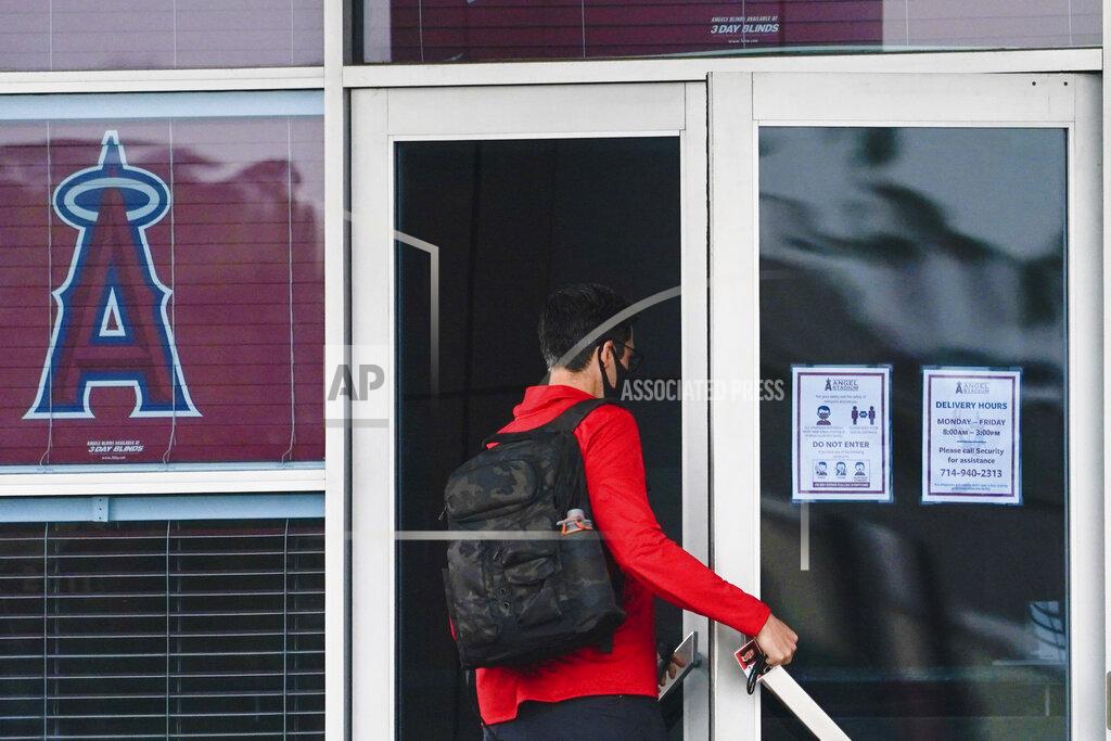 Ashley Landis A Los Angeles Angels employee enters Angels Stadium on Wednesday, July 1, 2020, in Anaheim, Calif. The Angels and other Major League Baseball teams will report to their respective facilities for training this week, amid the coronavirus pandemic. (AP Photo/Ashley Landis)