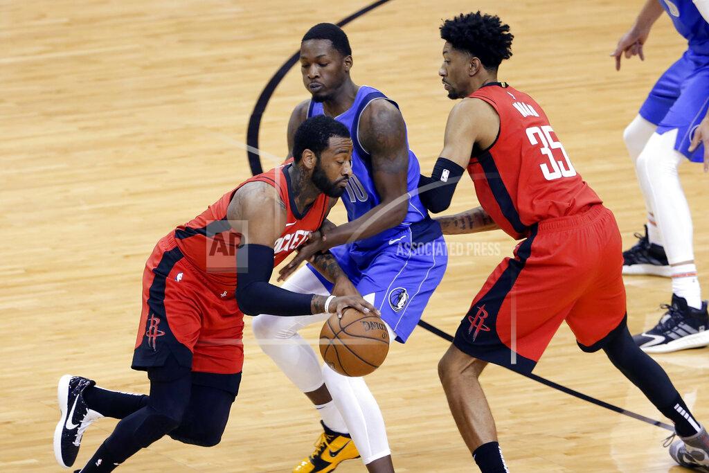 Michael Wyke Houston Rockets guard John Wall, left, drives around Dallas Mavericks forward Dorian Finney-Smith (10) as Rockets center Christian Wood (35) sets a screen during the first half of an NBA basketball game Wednesday, April 7, 2021, in Houston. (AP Photo/Michael Wyke, Pool)