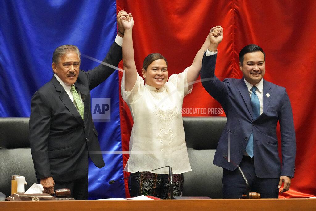 Aaron Favila Vice-president-elect Sara Duterte, center, raises hands with Senate President Vicente Sotto III, left, and House Speaker Lord Allan Velasco during her proclamation at the House of Representatives, Quezon City, Philippines on Wednesday, May 25, 2022. Sara is the daughter of outgoing president Rodrigo Duterte. (AP Photo/Aaron Favila)