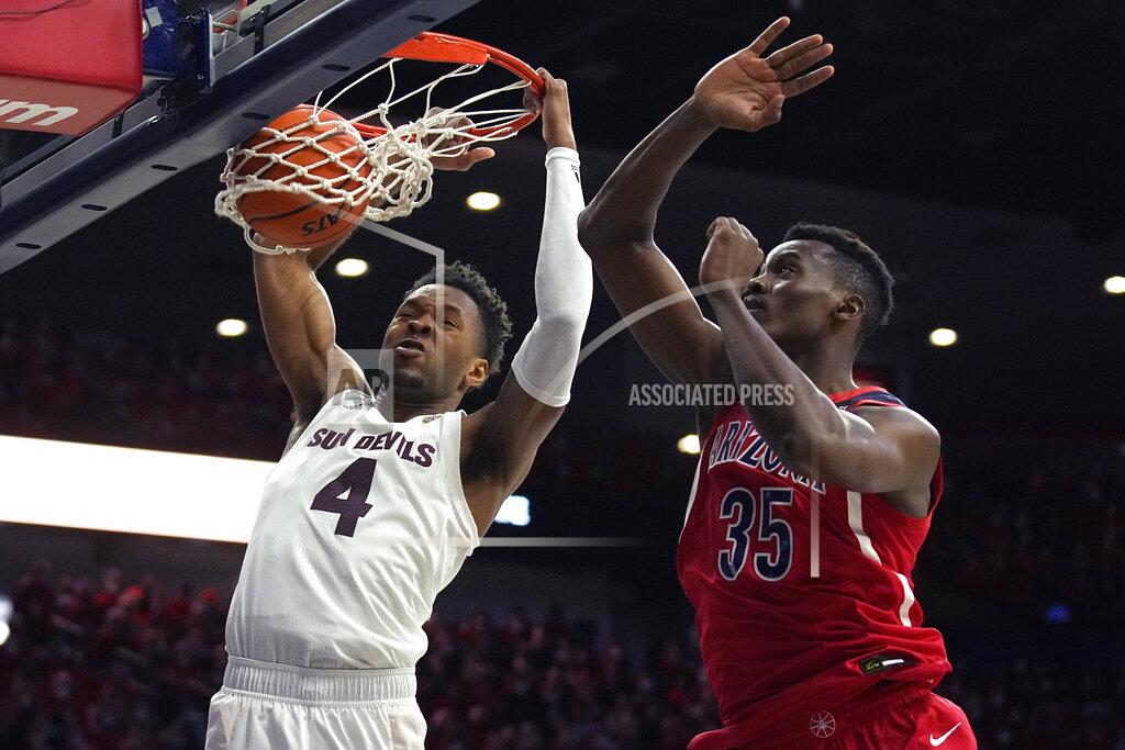 Rick Scuteri Arizona State forward Kimani Lawrence (4) dunks on Arizona center Christian Koloko during the first half of an NCAA college basketball game, Saturday, Jan. 29, 2022, in Tucson, Ariz. (AP Photo/Rick Scuteri)