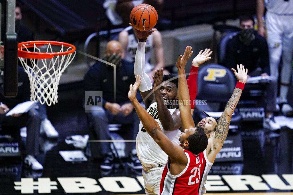 Michael Conroy Purdue forward Trevion Williams (50) shoots over Ohio State center Zed Key (23) and guard Duane Washington Jr. (4) during the second half of an NCAA college basketball game in West Lafayette, Ind., Wednesday, Dec. 16, 2020. (AP Photo/Michael Conroy)