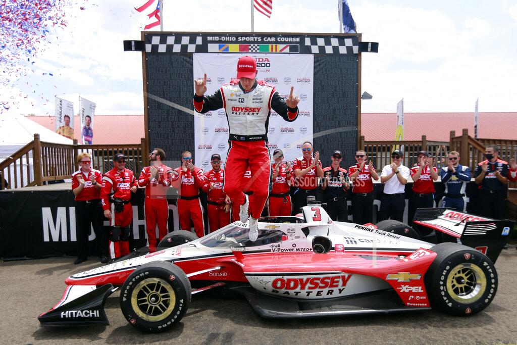 Tom E. Puskar Scott McLaughlin, center, celebrates in Victory Circle after his win in an IndyCar auto race at Mid-Ohio Sports Car Course in Lexington, Ohio, Sunday, July 3, 2022. (AP Photo/Tom E. Puskar)