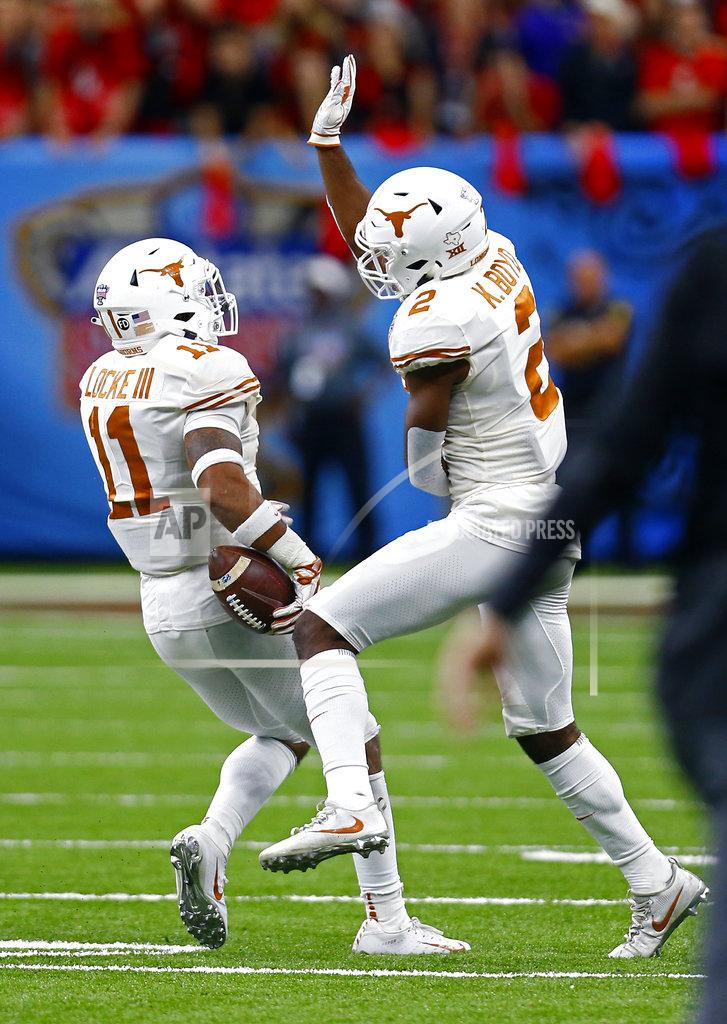 Butch Dill Texas defensive back P.J. Locke III (11) celebrates his interception with defensive back Kris Boyd (2) during the second half of the Sugar Bowl NCAA college football game against Georgia in New Orleans, Tuesday, Jan. 1, 2019. (AP Photo/Butch Dill)